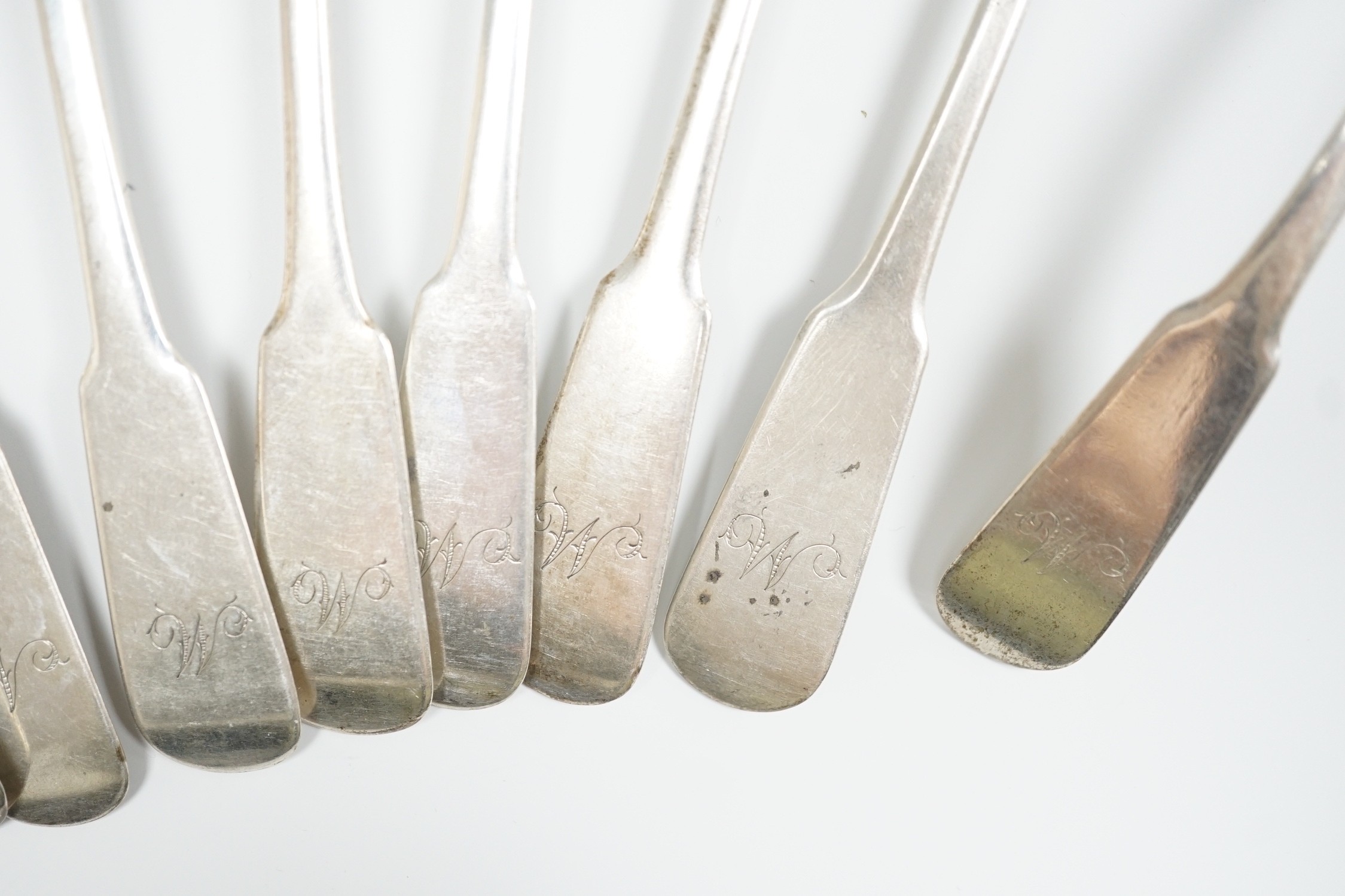 A set of nine early 19th century Scottish provincial silver fiddle pattern dessert spoons, 18.5cm and a pair of sauce ladles, by Alex MacLeod, Inverness, 11oz.